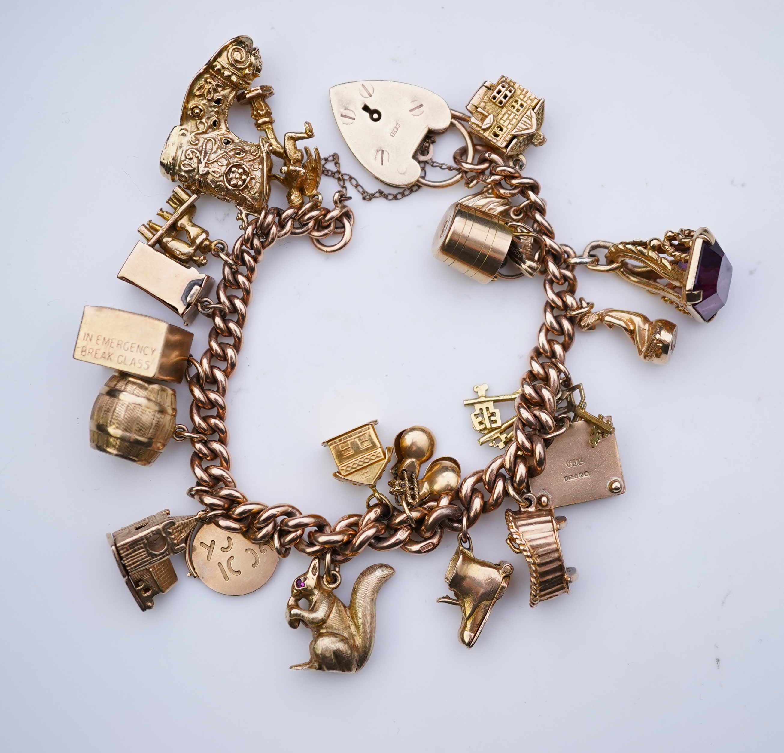 A 9ct gold charm bracelet, mid 20th century